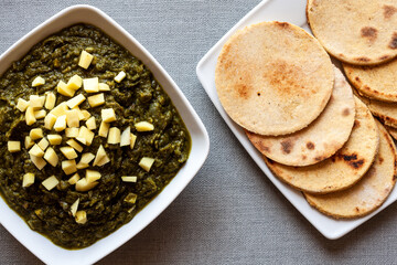 Mustard greens dish with corn roti flatbreads. Vegan Indian meal (Makki di roti with sarson ka saag).
