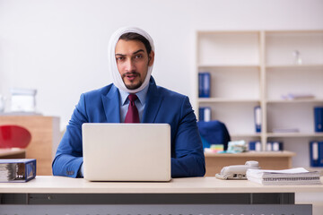 Young male employee suffering from toothache at workplace