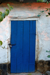 old house white wall with blue door