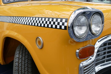 Details of the front of an old yellow cab of New York.