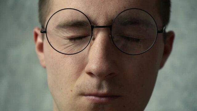 nervous tic of the eyes in an adult man. sick man blinks his eyes
