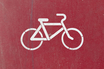 The red bike lane is marked with the bicycle symbol in white paint, top view.