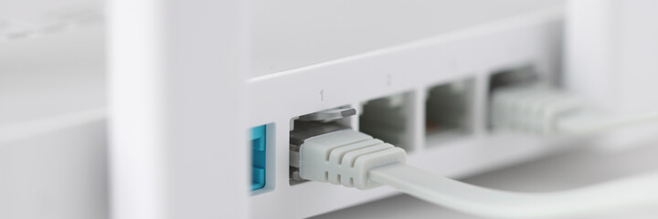 Network cable is plugged into socket of access point closeup