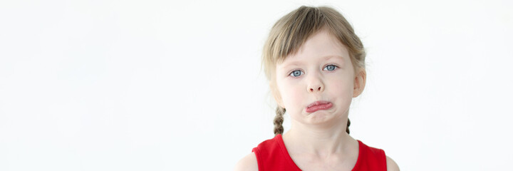 Portrait of little sad girl with blue eyes