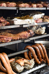 A large grill is used to cook different types of meat and vegetables. Street Food Festival.