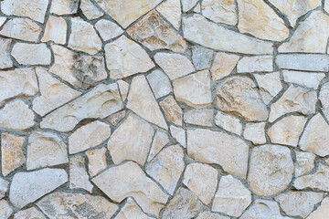 stone wall made of sandstone blocks of different sizes as the background
