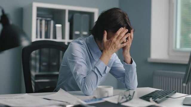 Exhausted woman sitting at office