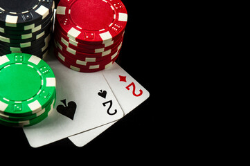 Poker game with one pair combination. Chips and cards on the black table in poker club.Free advertising space.
