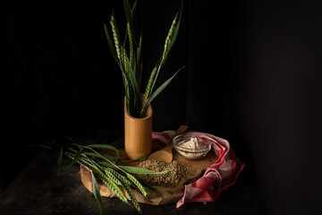Dark and moody food photography with ears of wheat and agricultural products for a healthy...