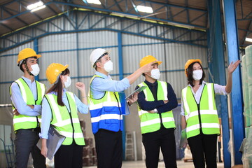 Team workers wear protective face masks for safety industrial factory. worker meeting before start working in factory or warehouse