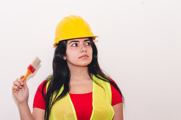 girl dressed as a worker holding a paintbrush in her hand.