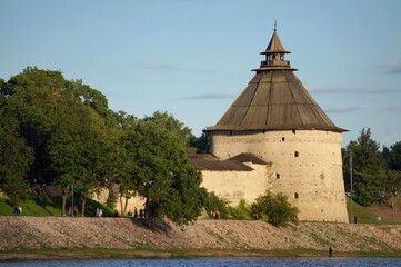 Russia. Pskov region. Pskov. View of the city. Pokrovskaya Tower on the banks of the Velikaya River on a summer sunny day