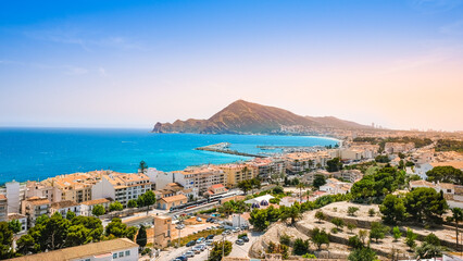 Altea, Spain - beautiful small town with beach, harbour, train and mountains at sunset. Popular Spanish tourist destination in Costa Blanca region on Mediterranean sea © Julia Lavrinenko