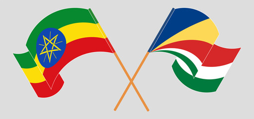 Crossed and waving flags of Ethiopia and Seychelles