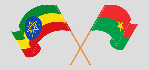 Crossed and waving flags of Ethiopia and Burkina Faso