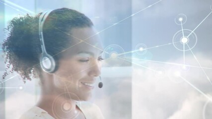 Animation of networks of connections over businesswoman using phone headsets - Powered by Adobe