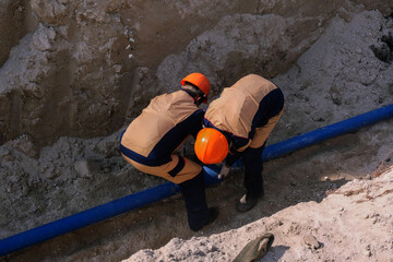 Workers are installing water supply pipeline system
