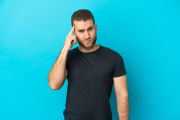 Young handsome caucasian man isolated on blue background thinking an idea