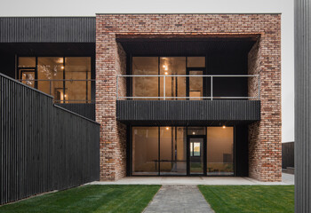 Modern luxury two-storey house in Australian style. Exterior of a modern building with brick...