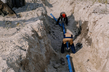 Workers are installing water supply pipeline system