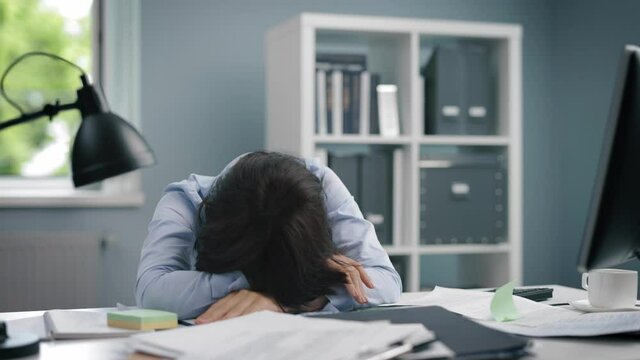 Overworked woman sitting at office