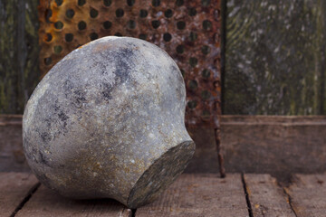 Still life with vintage metallic pot and rusted grater on the wooden table. Rural background with old objects.