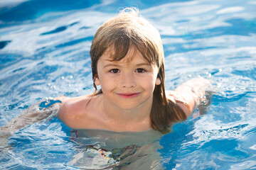 Portrait of little boy swim in sea. Kid laughing in water of waves at sea. Funny kids face.