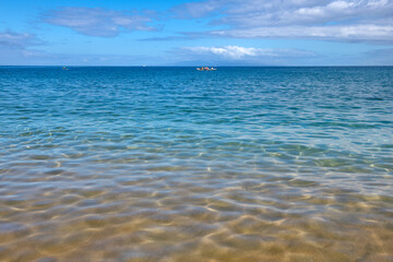 Abstract sea nature background. Water waves in sunlight with copy space. Tropical beach. Watering place. Aqua sea water surface.