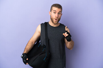 Fototapeta premium Young sport man with sport bag isolated on white background thinking an idea pointing the finger up