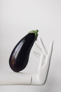 Eggplant Emoji On A White Background With White Mannequin Hand