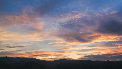 Colorful Sunset sky in mountains with clouds, Horizon. Warm Colours.