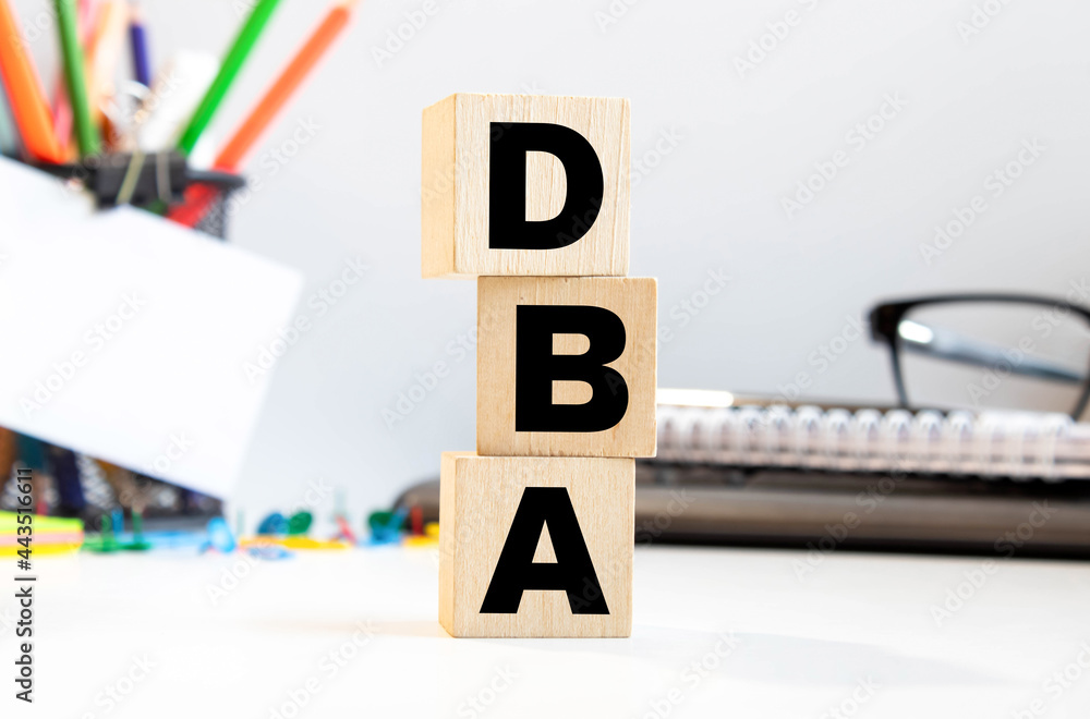 Poster dba - acronym from wooden blocks with letters, database administrator or doing business as abbreviat