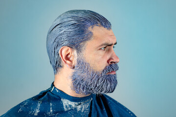 Portrait of man hair coloring. Bearded hipster guy. Process of a man having his hair color at...