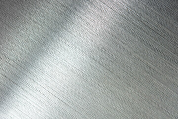 Photograph of brushed metal, or hair line pattern metal. Brushed metal with reflection. Diagonal...