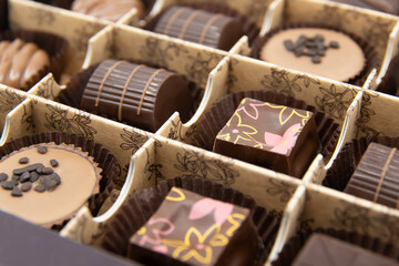 Chocolate candies set in an open box. Chocolate candy closeup. Assorted chocolate sweets.	
