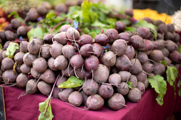 Red beets stacked on wooden table in a farmer's market