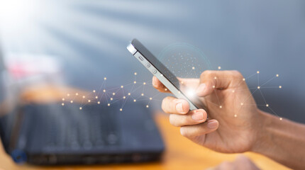 connection and  communication concept with man hand using mobile smartphone with network and blue copy space background