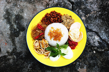 Savory rice with various complements, cooked in a traditional way using a burning stove to give a distinctive aroma and taste.