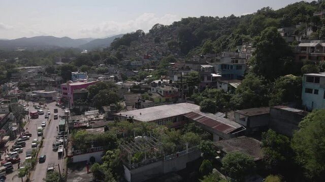Aerial View of Tamazunchale, Central Mexico. Street Traffic and Hillside Favela of Town in San Luis Potosi State, Drone Shot