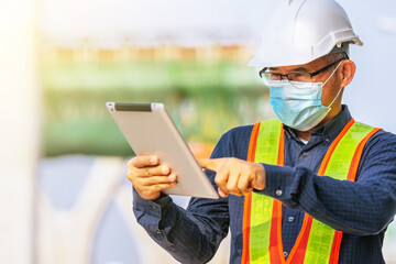 Engineer hold tablet working site construction