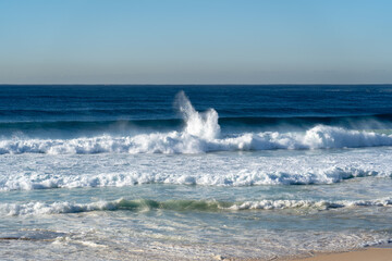 Big waves at the beach crashing onto the shore