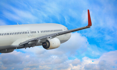 White passenger airplane over the clouds  - Travel by air transport