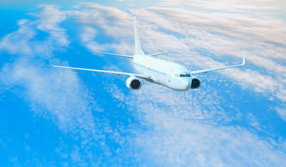 White passenger airplane over the clouds  - Travel by air transport