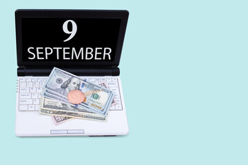 Laptop with the date of 9 september and cryptocurrency Bitcoin, dollars on a blue background. Buy or sell cryptocurrency. Stock market concept.