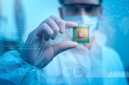 Engineer man  in sterile suit is holding Microchip with symbols in modern design factory  , futuristic and artificial intelligence concept