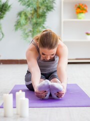 Young woman exercising in sports hall in healthy concept