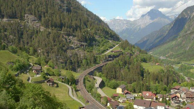 Timelapse cars and trains traffic in small Swiss Alpine town. Wassen, Canton Uri, Switzerland.