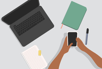 Hands holding the phone. Notepaper, laptop and marker on the table. Top-down view. Modern vector illustrated banner, web. Work from home concept.