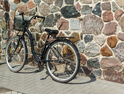 Vintage Bicycle Leaning against a Stone Wall