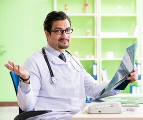 Doctor radiologist looking at x-ray scan in hospital
